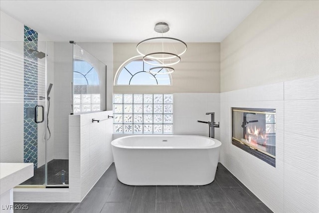 2842 Via Florentine St, Henderson, NV 89074 - bathroom with a freestanding tub, a shower stall, and tile walls