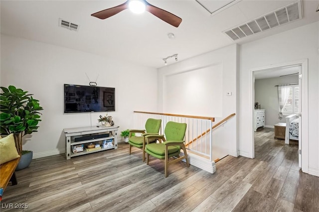 10372 Natural Springs Ave, Las Vegas, NV 89129 - living area with a ceiling fan, an upstairs landing, and wood finished floors