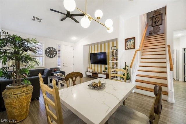 10372 Natural Springs Ave, Las Vegas, NV 89129 - dining room featuring stairs, wood finished floors, lofted ceiling, and a ceiling fan