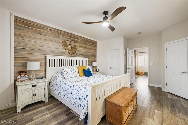 10372 Natural Springs Ave, Las Vegas, NV 89129 - bedroom with dark wood-style floors, wooden walls, and ceiling fan