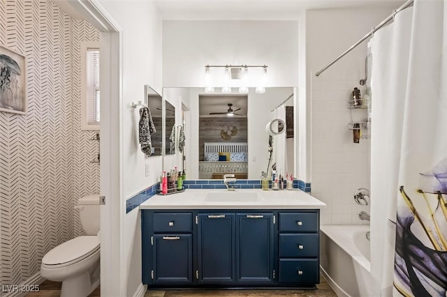 10372 Natural Springs Ave, Las Vegas, NV 89129 - bathroom featuring vanity, a ceiling fan, shower / bathtub combination with curtain, and tile walls