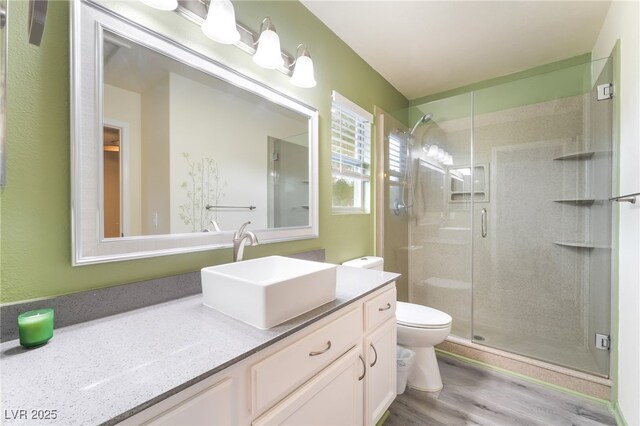 9578 Teton Vista Ave, Las Vegas, NV 89117 - bathroom with vanity, a shower stall, and wood finished floors