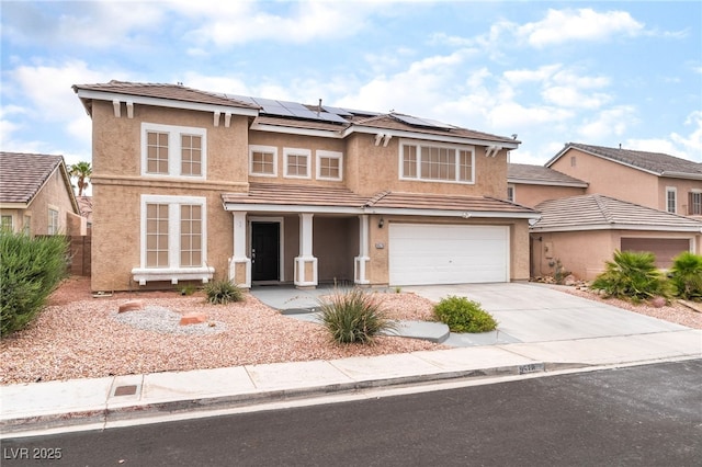 9578 Teton Vista Ave, Las Vegas, NV 89117 - traditional-style house with concrete driveway, stucco siding, roof mounted solar panels, an attached garage, and covered porch
