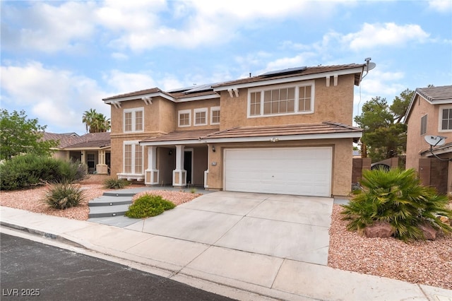 9578 Teton Vista Ave, Las Vegas, NV 89117 - traditional home with stucco siding, solar panels, driveway, an attached garage, and a tiled roof