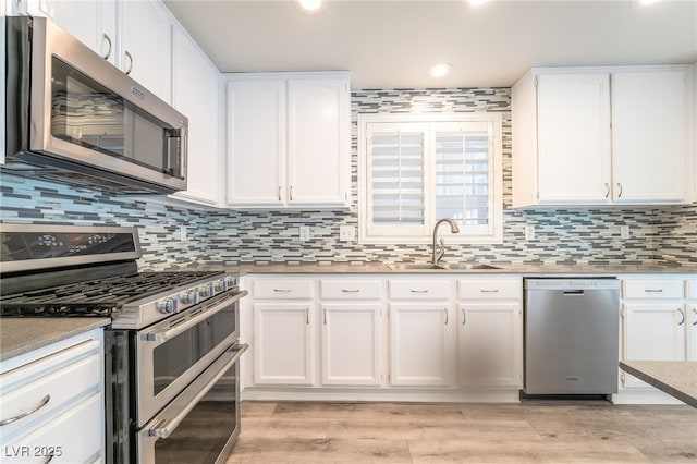 9578 Teton Vista Ave, Las Vegas, NV 89117 - kitchen featuring appliances with stainless steel finishes, white cabinetry, recessed lighting, backsplash, and light countertops