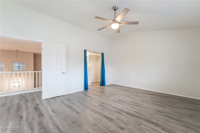 9578 Teton Vista Ave, Las Vegas, NV 89117 - empty room with a ceiling fan, wood finished floors, and vaulted ceiling