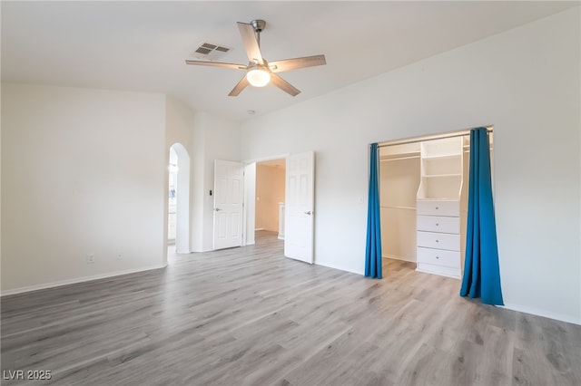 9578 Teton Vista Ave, Las Vegas, NV 89117 - unfurnished bedroom featuring wood finished floors, arched walkways, and ceiling fan