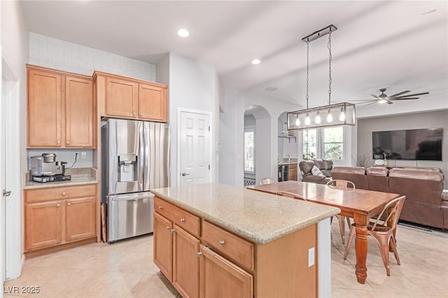 1521 Antler Creek St, North Las Vegas, NV 89084 - kitchen with stainless steel refrigerator with ice dispenser, arched walkways, open floor plan, ceiling fan, and light tile patterned floors