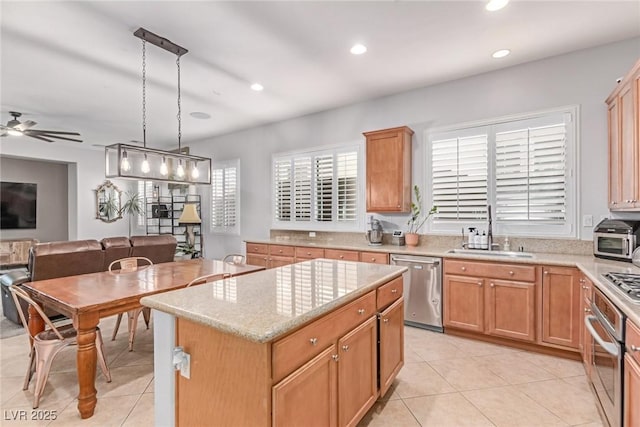 1521 Antler Creek St, North Las Vegas, NV 89084 - kitchen featuring stainless steel appliances, light tile patterned floors, ceiling fan, a center island, and recessed lighting