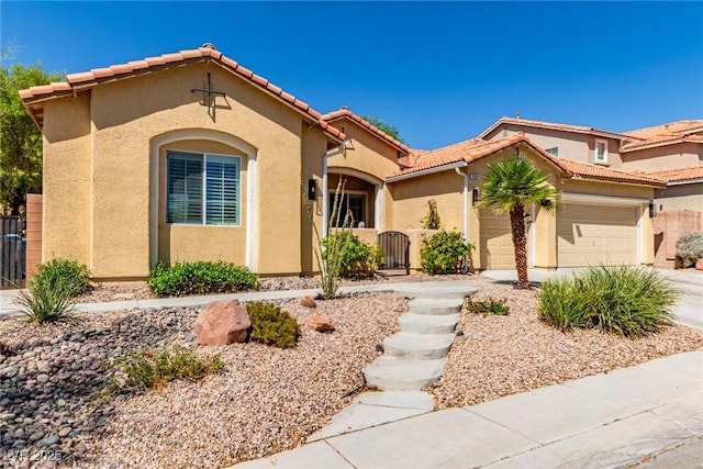 1521 Antler Creek St, North Las Vegas, NV 89084 - mediterranean / spanish house with stucco siding, an attached garage, a tile roof, and concrete driveway
