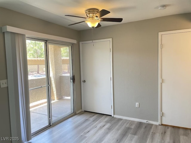2300 E Silverado Ranch Blvd Unit 1180, Las Vegas, NV 89183 - unfurnished bedroom featuring access to outside, light wood-style flooring, and ceiling fan