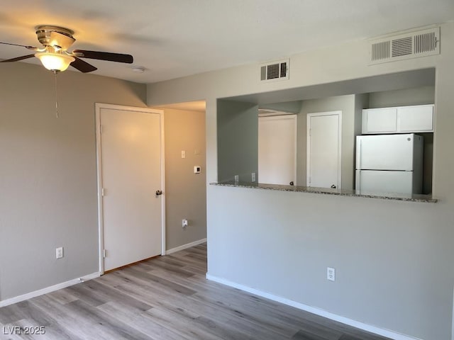 2300 E Silverado Ranch Blvd Unit 1180, Las Vegas, NV 89183 - empty room featuring a ceiling fan, wood finished floors, and a smoke detector