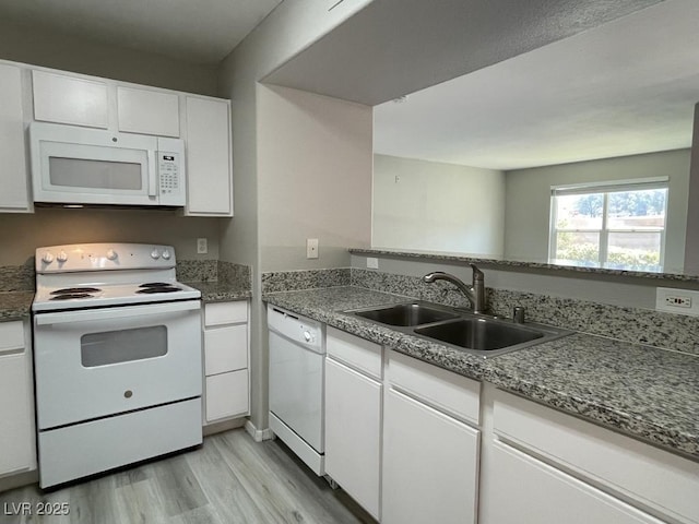 2300 E Silverado Ranch Blvd Unit 1180, Las Vegas, NV 89183 - kitchen featuring white appliances, light wood-type flooring, and white cabinetry