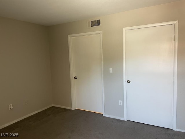 2300 E Silverado Ranch Blvd Unit 1180, Las Vegas, NV 89183 - unfurnished bedroom featuring dark carpet and baseboards
