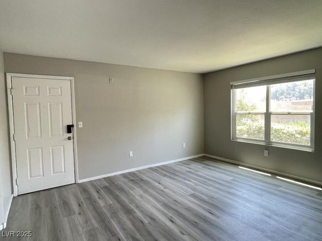 2300 E Silverado Ranch Blvd Unit 1180, Las Vegas, NV 89183 - unfurnished room featuring wood finished floors and baseboards