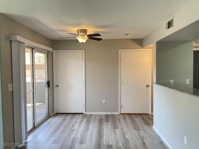 2300 E Silverado Ranch Blvd Unit 1180, Las Vegas, NV 89183 - empty room with light wood-style flooring and ceiling fan