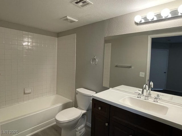 2300 E Silverado Ranch Blvd Unit 1180, Las Vegas, NV 89183 - bathroom featuring vanity, a textured ceiling, a textured wall, bathing tub / shower combination, and wood finished floors