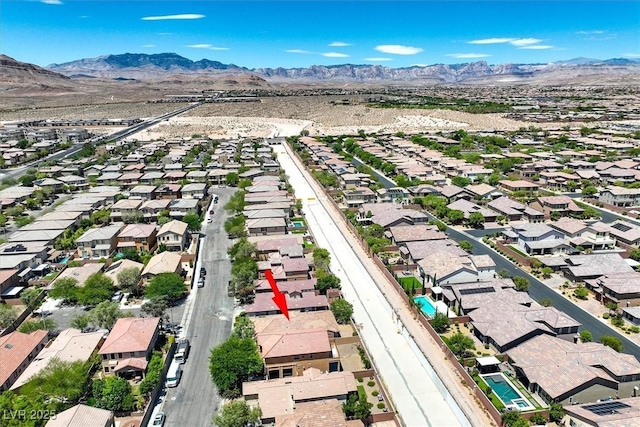7558 Schuders Ave, Las Vegas, NV 89178 - aerial overview of property's location featuring nearby suburban area and a mountainous background