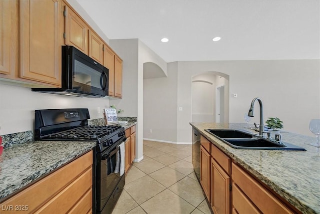 7558 Schuders Ave, Las Vegas, NV 89178 - kitchen featuring black appliances, arched walkways, light stone counters, light tile patterned flooring, and recessed lighting