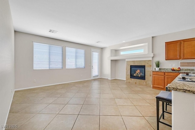 7558 Schuders Ave, Las Vegas, NV 89178 - living area with a tile fireplace and light tile patterned floors