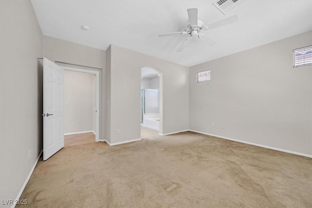 7558 Schuders Ave, Las Vegas, NV 89178 - empty room featuring carpet flooring, arched walkways, a ceiling fan, and plenty of natural light
