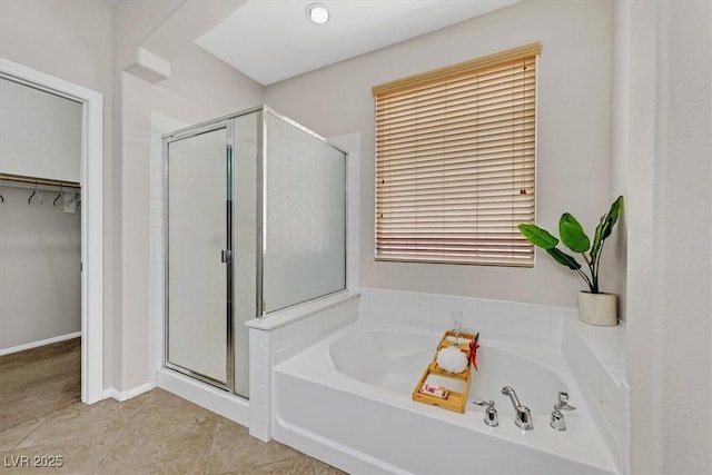 7558 Schuders Ave, Las Vegas, NV 89178 - full bathroom featuring a shower stall, a bath, and a spacious closet