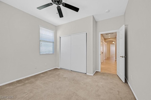7558 Schuders Ave, Las Vegas, NV 89178 - unfurnished bedroom with light carpet, a closet, ceiling fan, and arched walkways