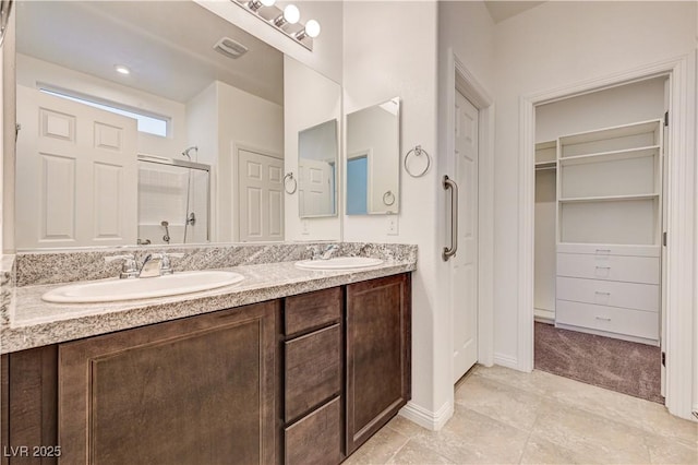 138 Red Sandstone Ave, North Las Vegas, NV 89031 - bathroom with a stall shower, double vanity, a walk in closet, and tile patterned floors