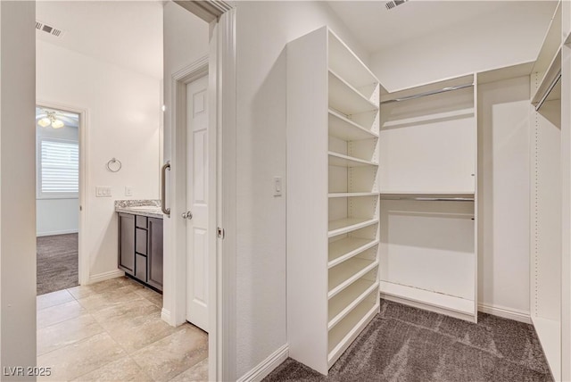138 Red Sandstone Ave, North Las Vegas, NV 89031 - walk in closet with light colored carpet and a ceiling fan