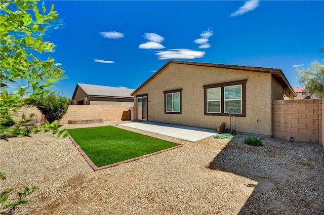 138 Red Sandstone Ave, North Las Vegas, NV 89031 - rear view of property with a fenced backyard, stucco siding, and a patio area
