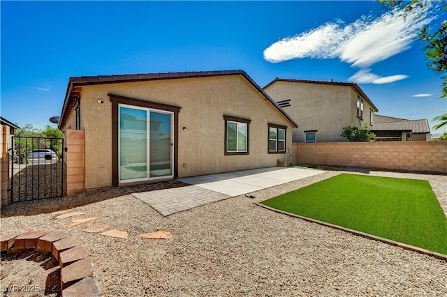 138 Red Sandstone Ave, North Las Vegas, NV 89031 - rear view of property with stucco siding, a patio area, and a gate