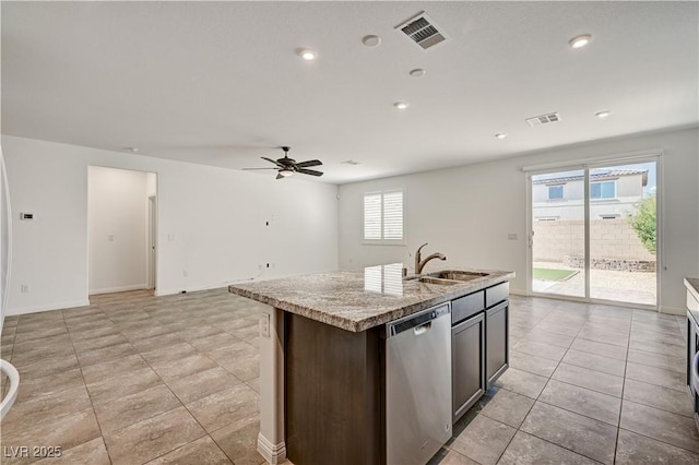 138 Red Sandstone Ave, North Las Vegas, NV 89031 - kitchen with stainless steel dishwasher, a ceiling fan, an island with sink, open floor plan, and light tile patterned floors