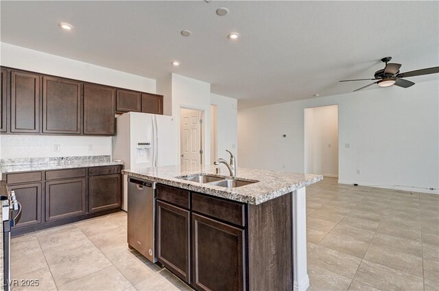 138 Red Sandstone Ave, North Las Vegas, NV 89031 - kitchen with dishwasher, white fridge with ice dispenser, a ceiling fan, an island with sink, and light stone counters