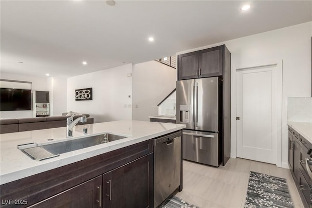 3244 Timorasso Ave, Henderson, NV 89044 - kitchen featuring stainless steel appliances, open floor plan, dark brown cabinets, recessed lighting, and light stone counters