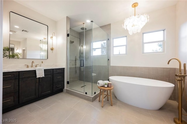 516 Pinnacle Heights Ln, Las Vegas, NV 89144 - bathroom with a stall shower, a soaking tub, vanity, wainscoting, and tile patterned floors