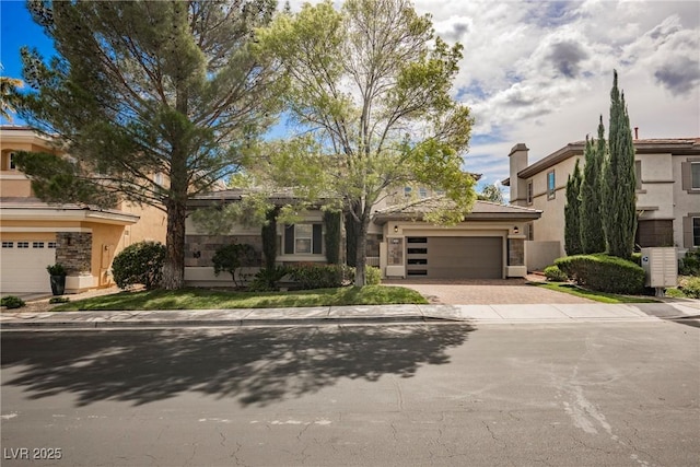 516 Pinnacle Heights Ln, Las Vegas, NV 89144 - view of front of house with stucco siding, decorative driveway, and an attached garage