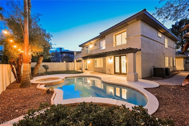 516 Pinnacle Heights Ln, Las Vegas, NV 89144 - rear view of house with a fenced backyard, stucco siding, a pool with connected hot tub, and a patio area