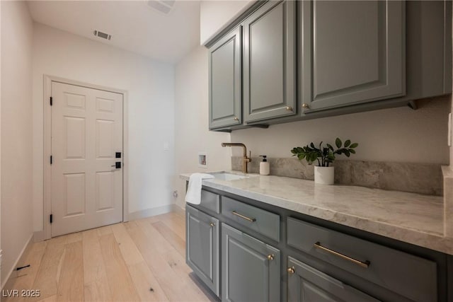516 Pinnacle Heights Ln, Las Vegas, NV 89144 - laundry area featuring hookup for a washing machine, light wood-style floors, and cabinet space