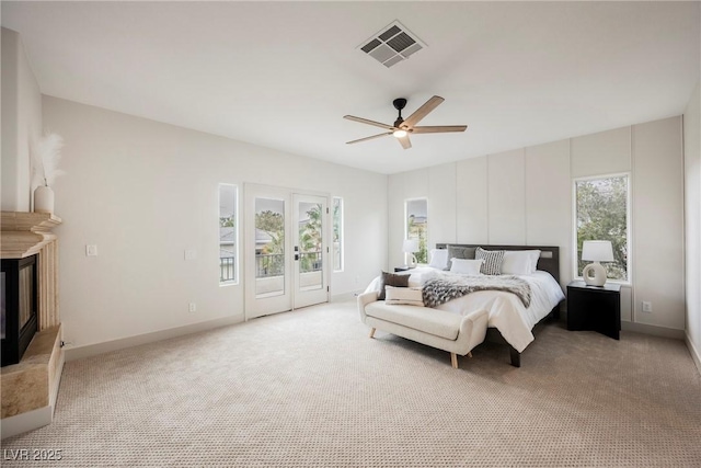 516 Pinnacle Heights Ln, Las Vegas, NV 89144 - bedroom featuring access to outside, light carpet, french doors, and a glass covered fireplace