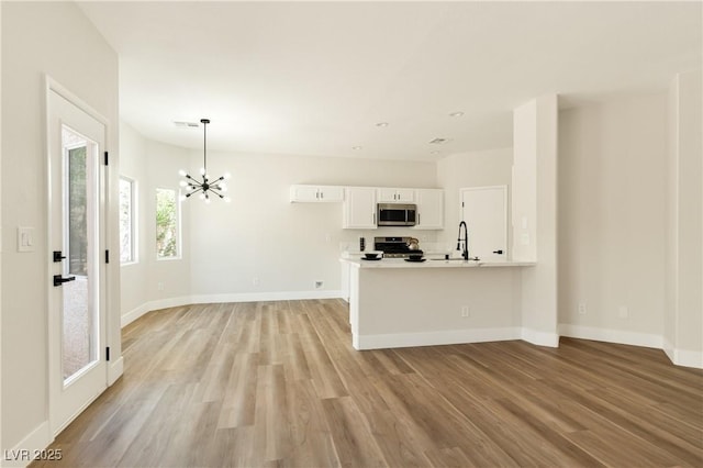 9349 Lakefront Color St, Las Vegas, NV 89178 - unfurnished living room with a chandelier and light wood-type flooring