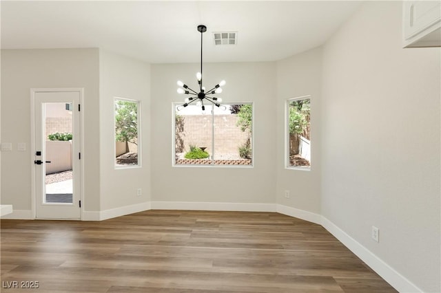 9349 Lakefront Color St, Las Vegas, NV 89178 - unfurnished dining area featuring a chandelier, healthy amount of natural light, and light wood-style flooring
