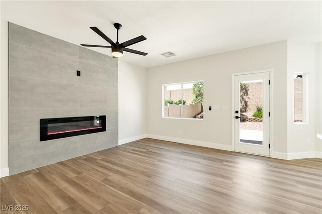 9349 Lakefront Color St, Las Vegas, NV 89178 - unfurnished living room with a fireplace, wood finished floors, ceiling fan, and heating unit