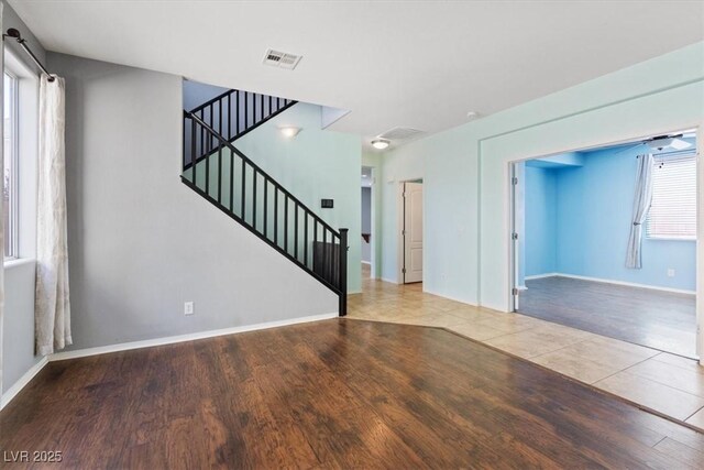 10645 Mount Jefferson Ave, Las Vegas, NV 89166 - unfurnished living room with wood finished floors and stairway