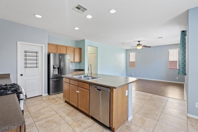 10645 Mount Jefferson Ave, Las Vegas, NV 89166 - kitchen with appliances with stainless steel finishes, light tile patterned floors, a center island with sink, a ceiling fan, and recessed lighting