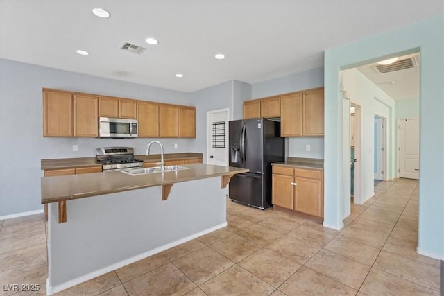 10645 Mount Jefferson Ave, Las Vegas, NV 89166 - kitchen featuring appliances with stainless steel finishes, a kitchen island with sink, a breakfast bar area, recessed lighting, and light tile patterned flooring