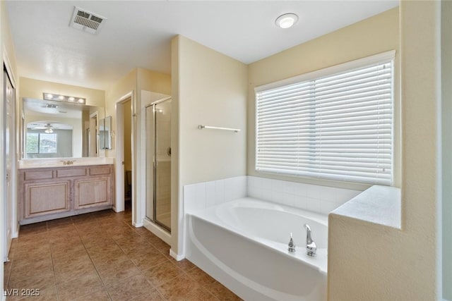 3613 Rubio Sun Ave, North Las Vegas, NV 89081 - full bath with a shower stall, vanity, a bath, and tile patterned flooring