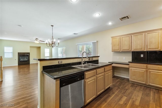 3613 Rubio Sun Ave, North Las Vegas, NV 89081 - kitchen featuring stainless steel dishwasher, light brown cabinets, a center island with sink, dark wood-type flooring, and a glass covered fireplace
