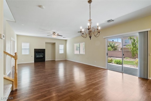 3613 Rubio Sun Ave, North Las Vegas, NV 89081 - unfurnished living room with ceiling fan, plenty of natural light, a glass covered fireplace, and a chandelier
