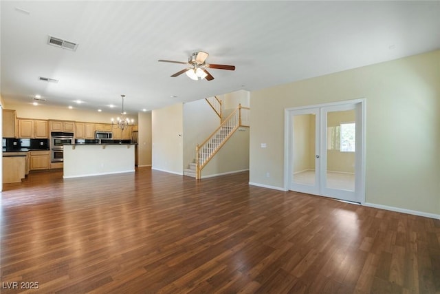 3613 Rubio Sun Ave, North Las Vegas, NV 89081 - unfurnished living room featuring stairway, ceiling fan, dark wood finished floors, a chandelier, and french doors