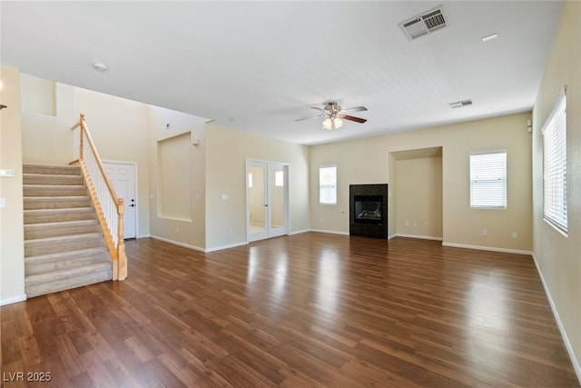 3613 Rubio Sun Ave, North Las Vegas, NV 89081 - unfurnished living room with plenty of natural light, a ceiling fan, wood finished floors, and stairs